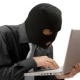 Cybersecurity illustration of a person using a laptop